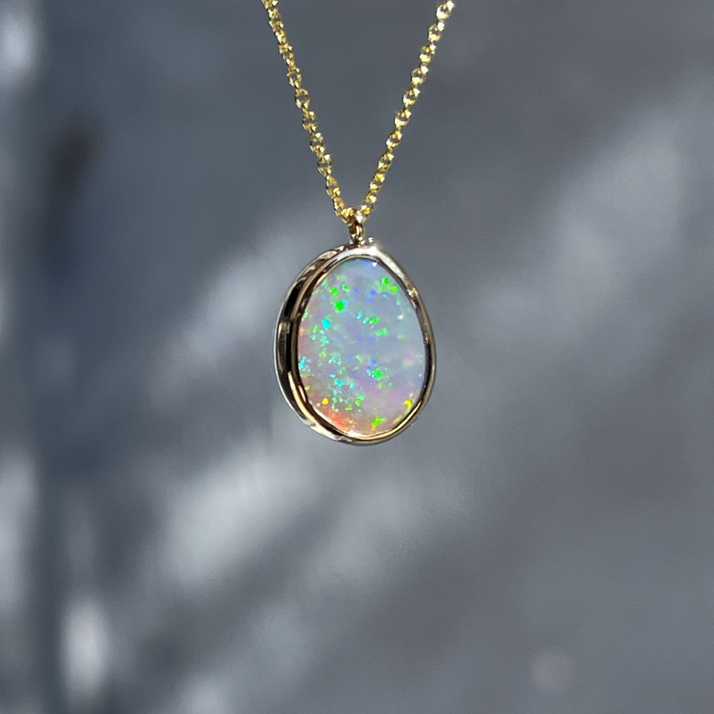 An Australian Opal Necklace by NIXIN Jewelry with a Lightning Ridge Black Opal in a bezel setting.