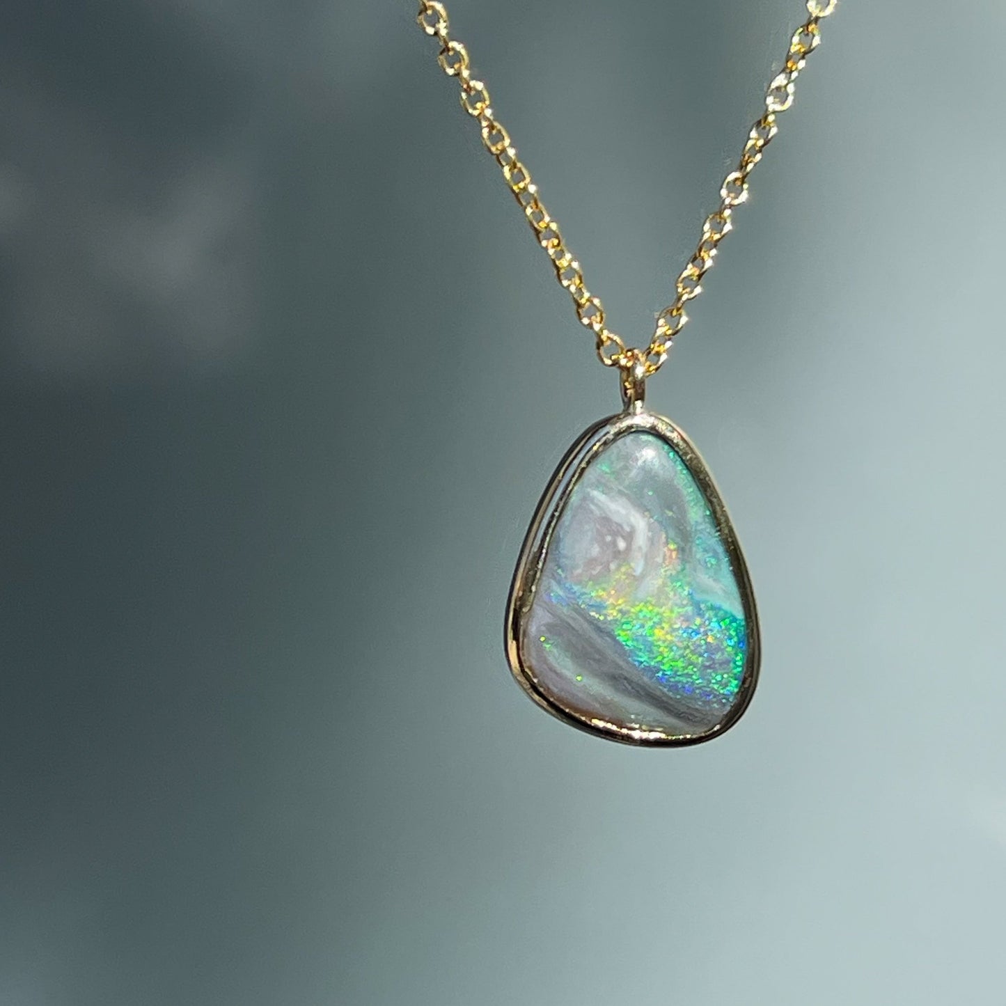 An Australian Opal Necklace by NIXIN Jewelry. The opal pendant is bezel set with a Lightning Ridge Opal. 