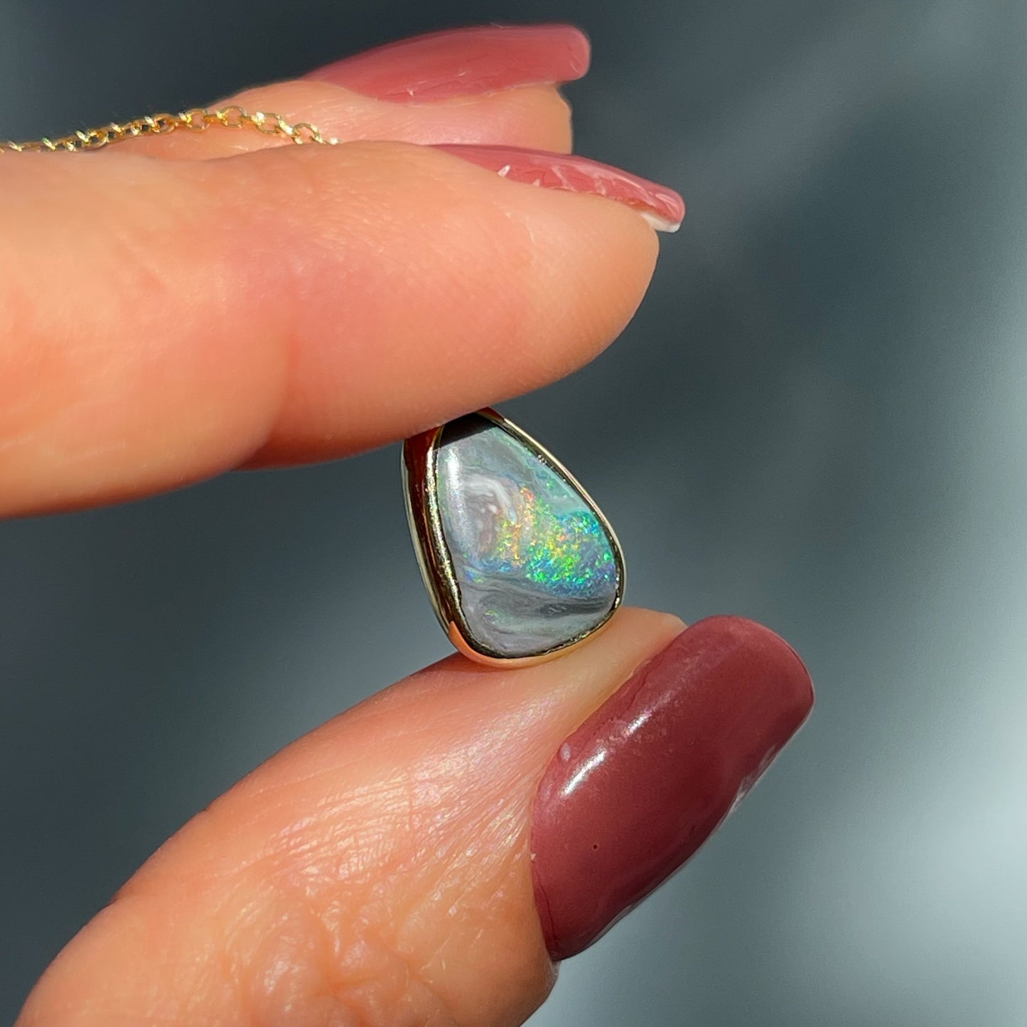 An Australian Opal Necklace by NIXIN Jewelry. A gold opal necklace in a bezel setting.