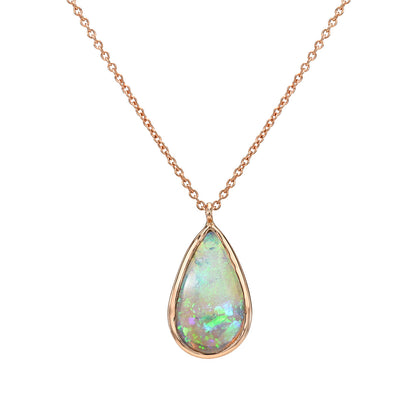 An Australian Opal Necklace by NIXIN Jewelry featuring the Unicorn Tear opal pendant in a clean studio shot. This luxury necklace showcases the green and blue fire of a genuine natural opal in a simple bezel setting. This unique opal necklace is jewelry art for collectors seeking rare opal jewelry.