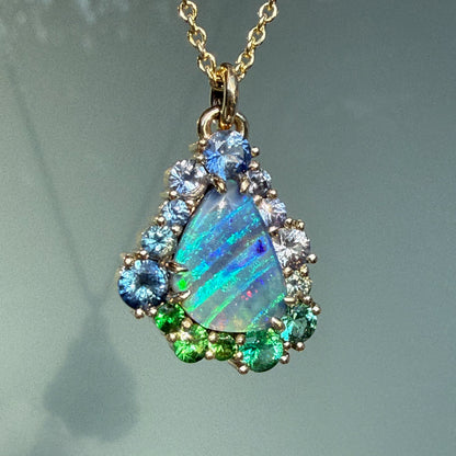 A detailed close-up of an Australian Opal Necklace by NIXIN Jewelry reveals the intricate prongs that hold the gemstones in place. This gold opal necklace is a prime example of luxury jewelry, blending natural Australian opal with high-end sapphire necklace details.