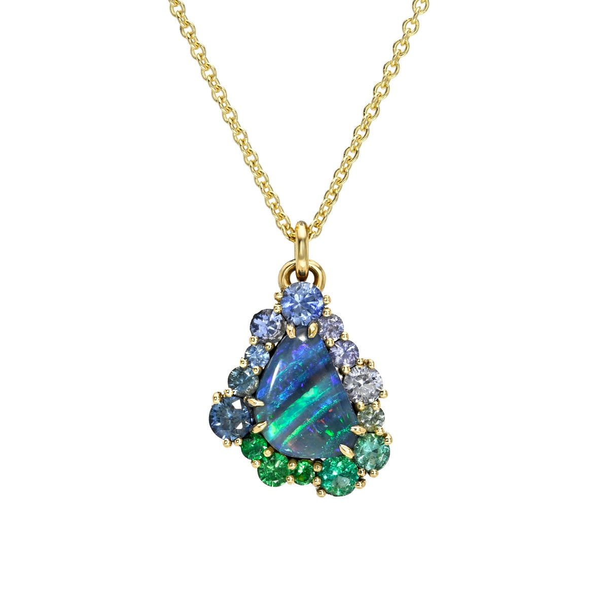 This studio image features an Australian Opal Necklace by NIXIN Jewelry, centered with a vibrant boulder opal with mesmerizing play-of-color. The unique fine jewelry is elevated by an ombre halo of sapphires and emeralds, securely held within prong settings. This women's luxury necklace serves as a piece of jewelry art.