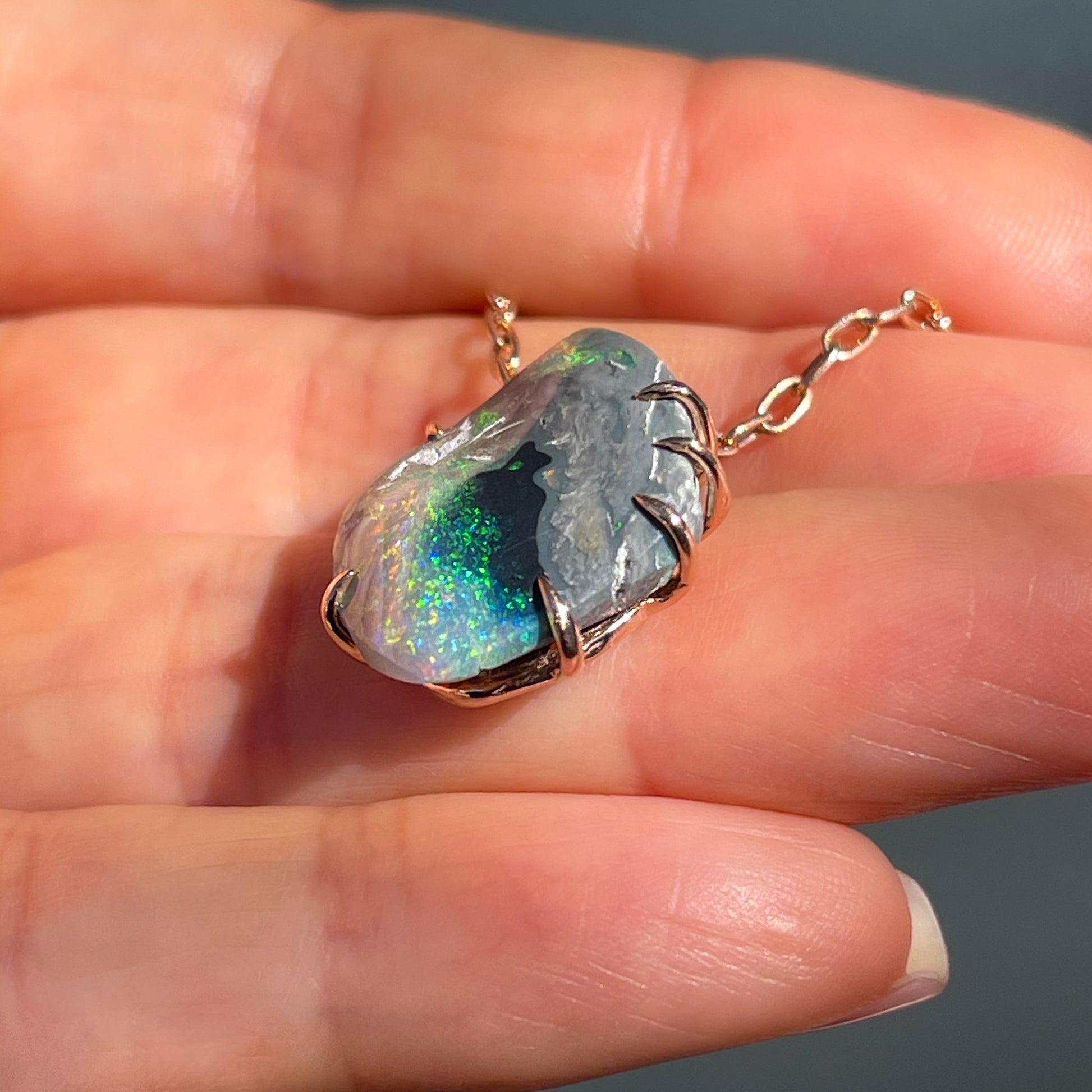 Angled view of an Australian Opal Necklace showing the side of the claw prongs around the raw opal.