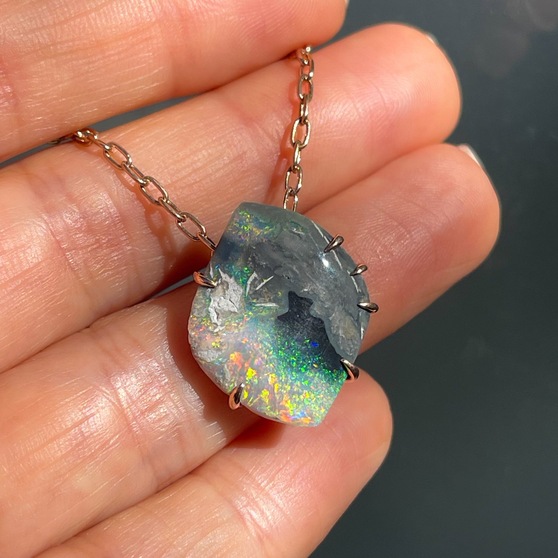 An Australian Opal Necklace with a Lightning Ridge Opal. A rose gold opal pendant.