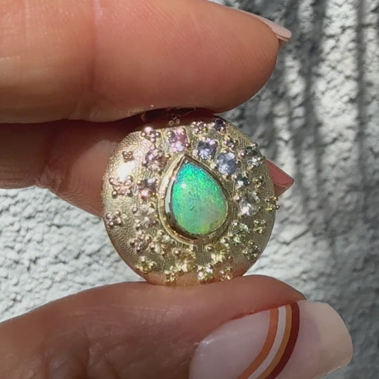 An Australian Opal Necklace by NIXIN Jewelry is showcased in this video, revealing its dynamic play-of-color. The video shows the dazzling crystal opal and the brilliance of the surrounding sapphires in motion.