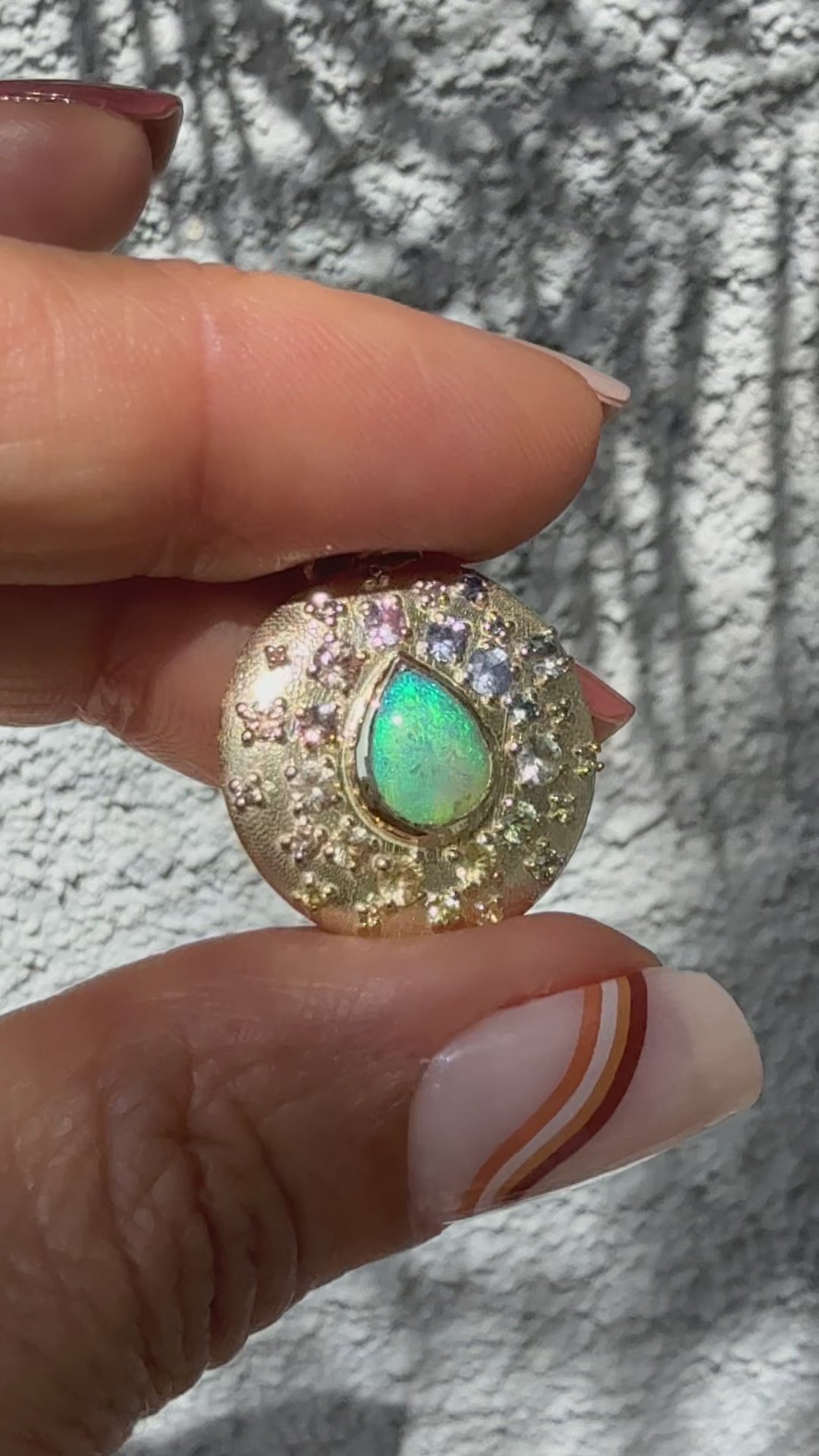 An Australian Opal Necklace by NIXIN Jewelry is showcased in this video, revealing its dynamic play-of-color. The video shows the dazzling crystal opal and the brilliance of the surrounding sapphires in motion.