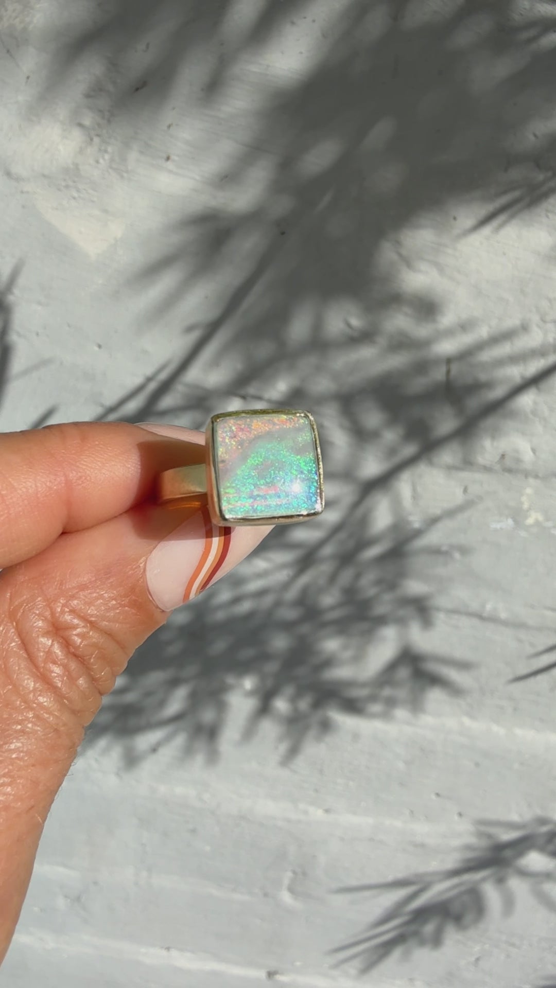 An Australian Opal Ring by NIXIN Jewelry, captured in motion. See the incredible play of light in this rare black opal ring, a true piece of luxury jewelry art.