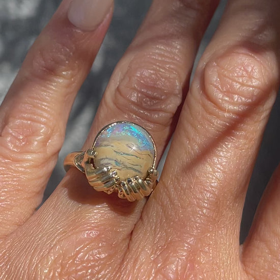 Video of an Australian Opal Ring by NIXIN Jewelry worn on a hand. A stunning example of rare opal jewelry.