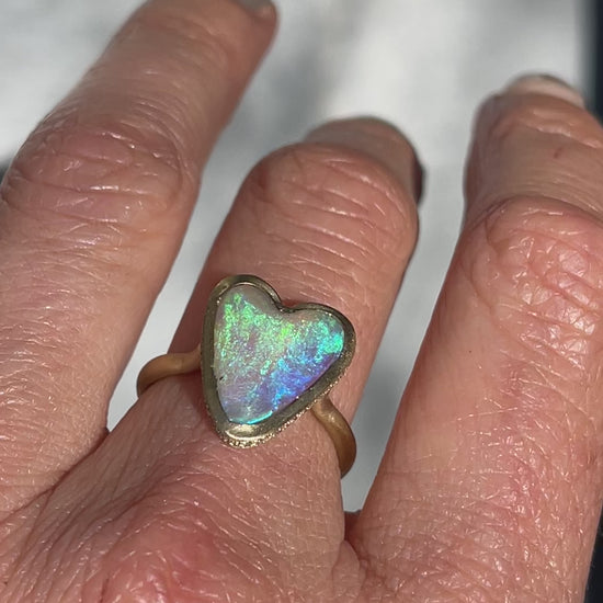 Video of an Australian Opal Ring by NIXIN Jewelry with an opal heart and a diamond halo.