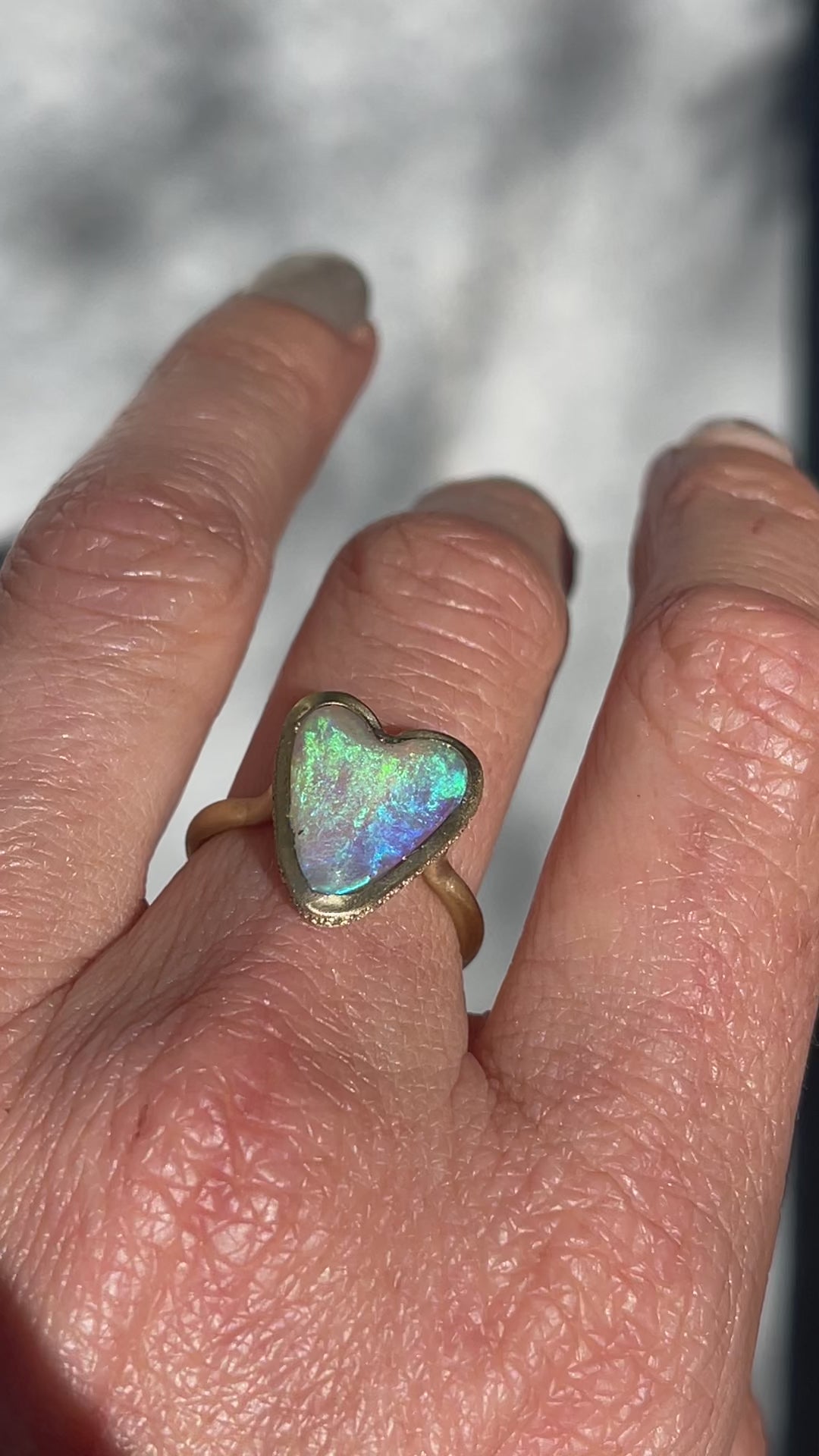 Video of an Australian Opal Ring by NIXIN Jewelry with an opal heart and a diamond halo.