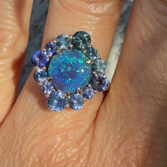 An Australian Opal Ring by NIXIN Jewelry. This video thumbnail shows the full play-of-color and fire of the black opal, confirming its status as a spectacular lightning ridge opal ring. The modern opal ring design classifies this piece as art, suitable for showcasing both luxury and boldness.