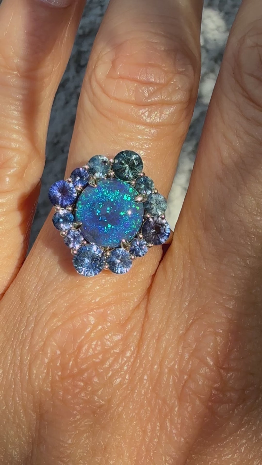 An Australian Opal Ring by NIXIN Jewelry. This video thumbnail shows the full play-of-color and fire of the black opal, confirming its status as a spectacular lightning ridge opal ring. The modern opal ring design classifies this piece as art, suitable for showcasing both luxury and boldness.