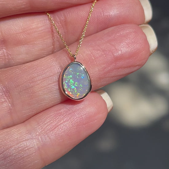 Video of an Australian Opal Necklace by NIXIN Jewelry showing the green and coral flash of the Lightning Ridge Black Opal.