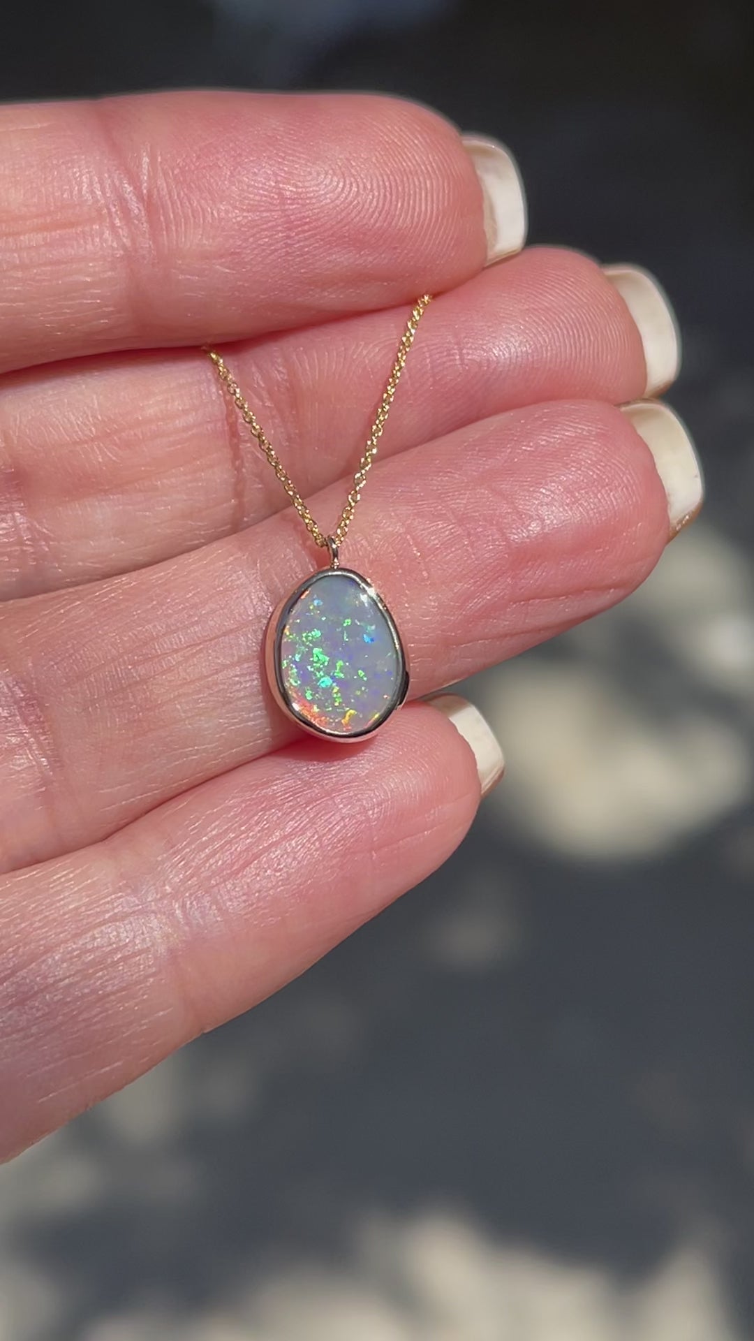 Video of an Australian Opal Necklace by NIXIN Jewelry showing the green and coral flash of the Lightning Ridge Black Opal.