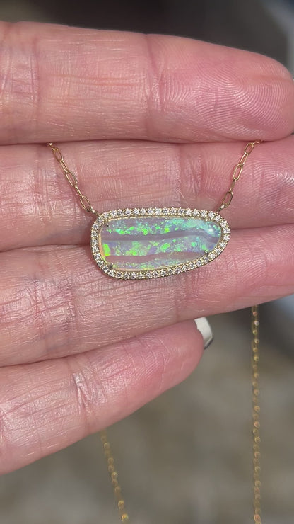 Video of an Australian Opal Necklace by NIXIN Jewelry with a Crystal Opal and pave diamonds set in gold. A unique opal necklace.