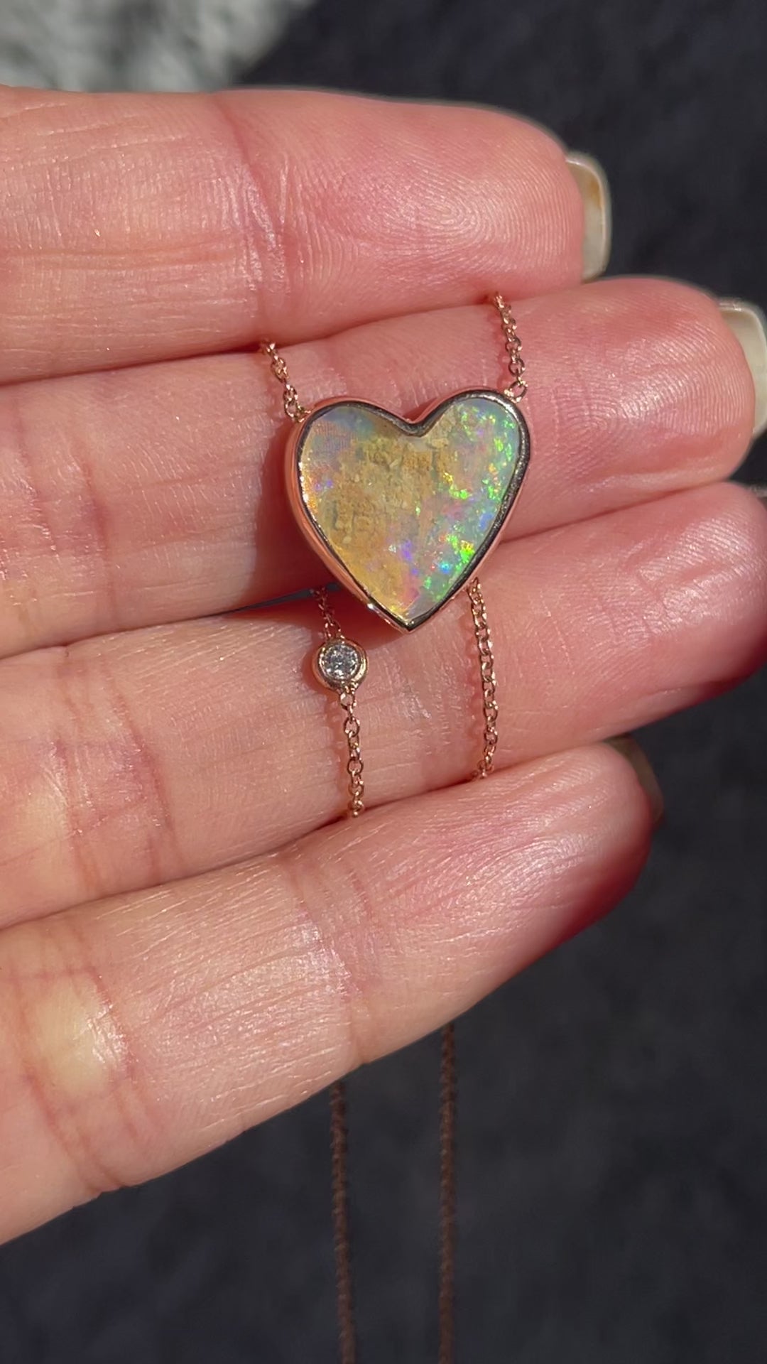 Video of an Australian Opal Necklace by NIXIN Jewelry with an opal heart and diamond set in rose gold.