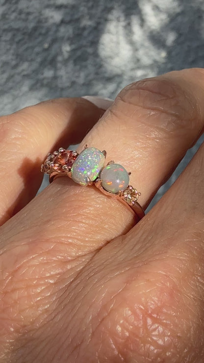 An Australian Opal Ring by NIXIN Jewelry shown in motion, capturing the dramatic fire and color transition of the sapphire opal ring. The video highlights the unique semi black opal patterns (pinfire and flash) amplifying the peach ombre sapphire gradient. This luxury ring video is critical for showing the true depth of the rare opal jewelry.