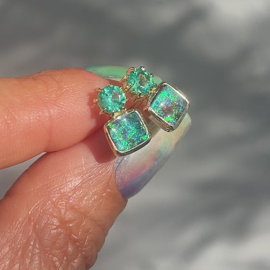 Video of Australian Opal Earrings by NIXIN Jewelry. Shows the vibrant boulder opals and the emeralds in the sunlight.