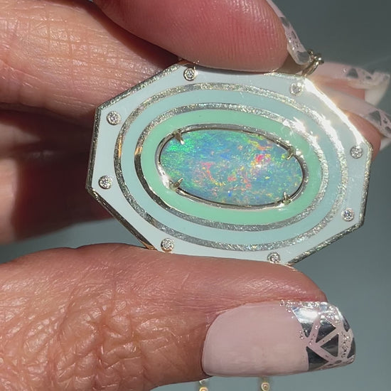 Video of an Australian Opal Necklace by NIXIN Jewelry. Shows the natural opal against the beauty of an enamel necklace.