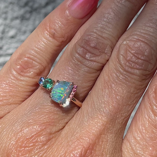 Video of an Australian Opal Ring by NIXIN Jewelry with a Boulder Opal, a Zambian Emerald and rainbow sapphires.