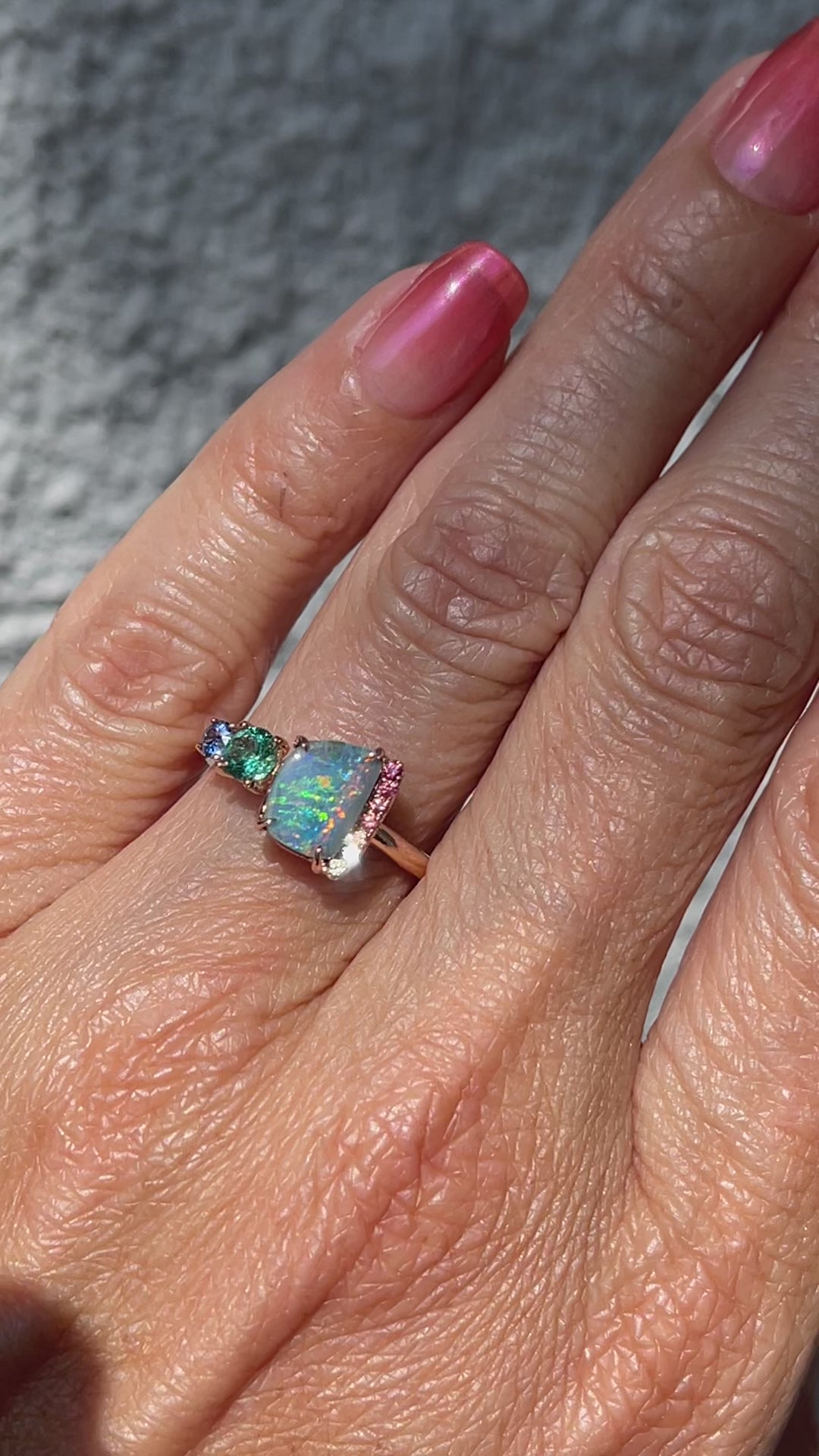 Video of an Australian Opal Ring by NIXIN Jewelry with a Boulder Opal, a Zambian Emerald and rainbow sapphires.