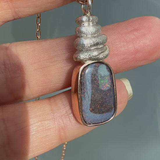 This video captures the dynamic movement and shifting sparks of fire in an Australian Opal Necklace by NIXIN Jewelry. Watch as the rare opal necklace flickers with unexpected pinks and greens, demonstrating the life within the boulder opal. This luxury necklace video brings the unique opal jewelry to life for the discerning buyer.