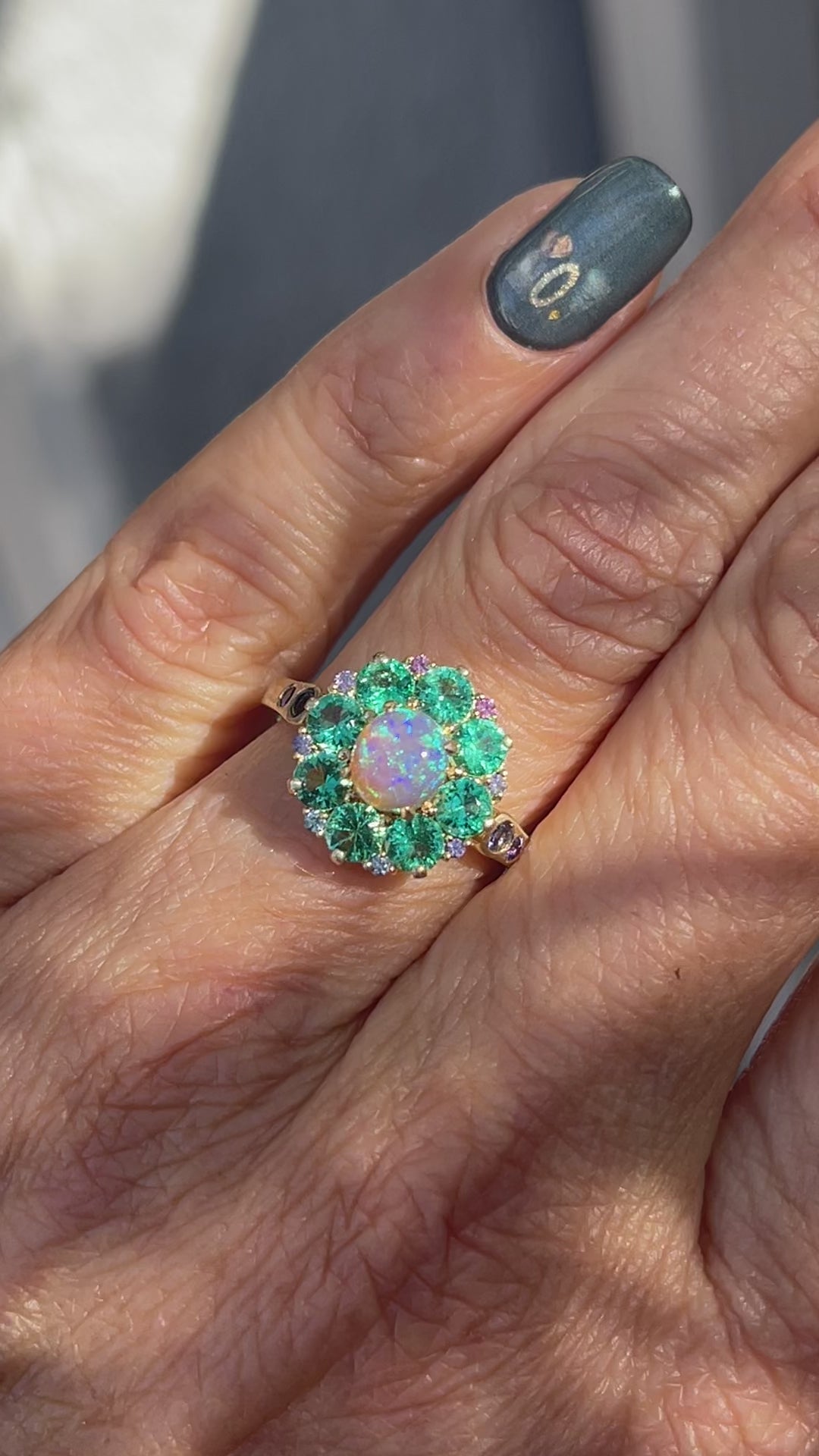 Video of an Australian Opal Ring by NIXIN Jewelry modeled on a hand. The crystal opal ring is rare fine jewelry.