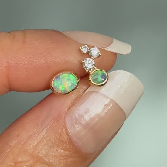 Australian Opal Earrings by NIXIN Jewelry. Video showcasing the intense light-play in the black opal and crystal opal stones as they move. The motion highlights the unique opal earrings design and diamond sparkle, perfect for luxury jewelry enthusiasts.