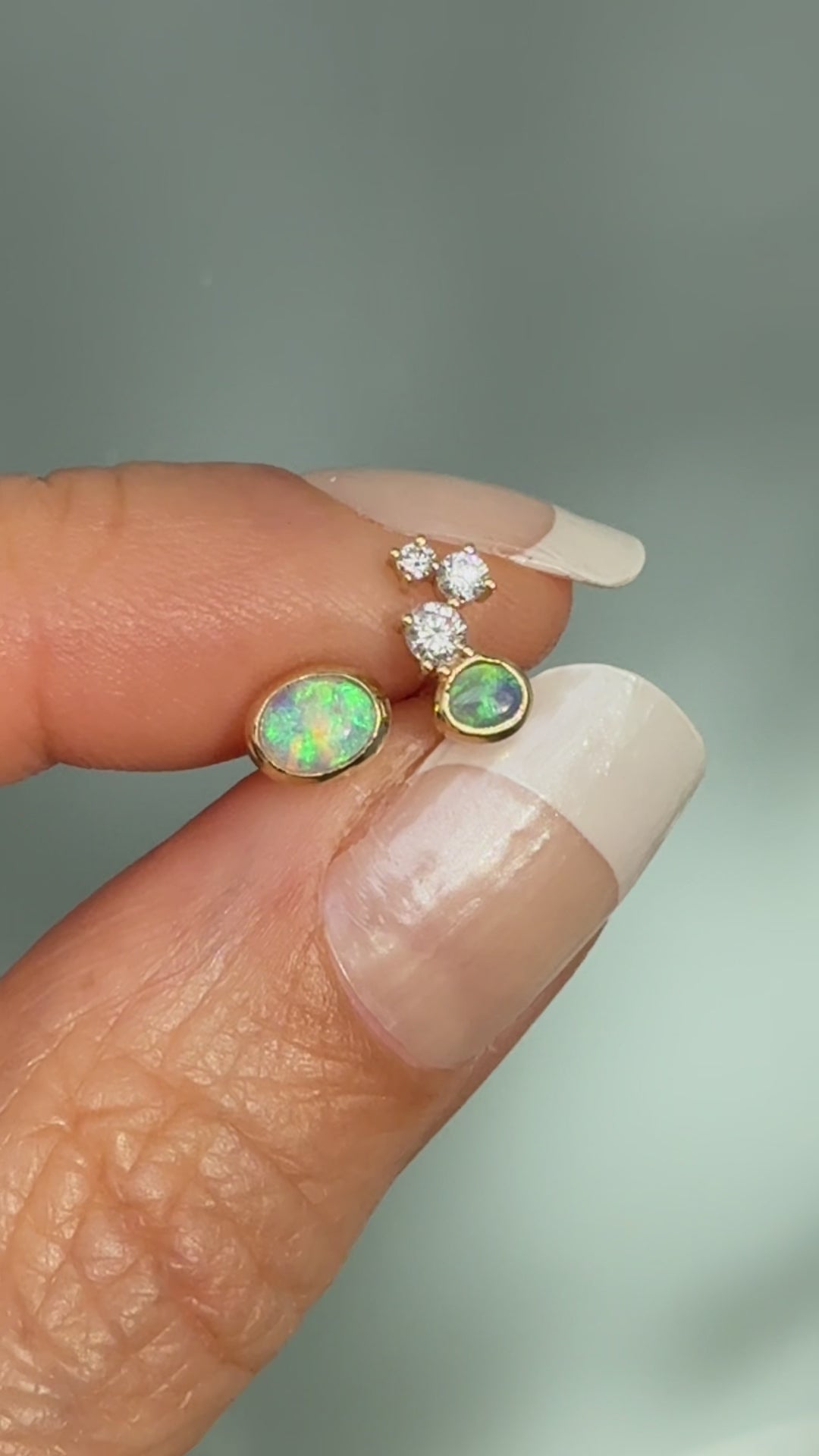 Australian Opal Earrings by NIXIN Jewelry. Video showcasing the intense light-play in the black opal and crystal opal stones as they move. The motion highlights the unique opal earrings design and diamond sparkle, perfect for luxury jewelry enthusiasts.