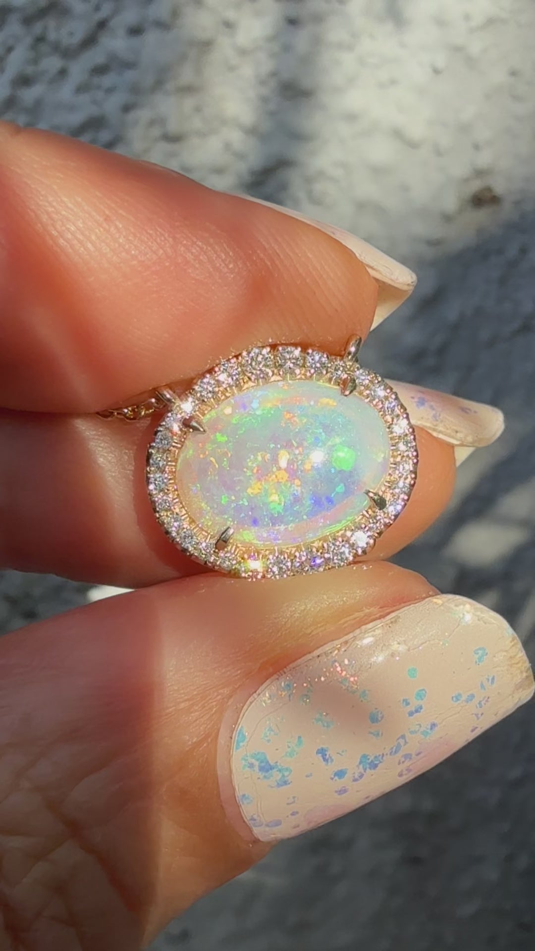 Video of an Australian Opal Necklace by NIXIN Jewelry, displaying the dynamic color shift of the crystal opal as it moves in natural light. This luxury jewelry video highlights the brilliance of the diamond halo and the mesmerizing nature of the unique opal pendant. The perfect representation of a rare opal necklace.