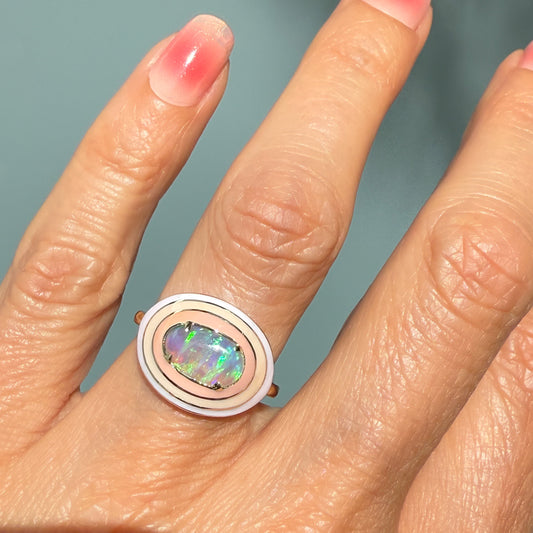 An Australian Opal Ring by NIXIN Jewelry, presenting a full view of the hand on which the ring is worn. This luxury jewelry piece is an exceptional example of a lightning ridge opal ring, perfect for those looking for a rare opal ring.