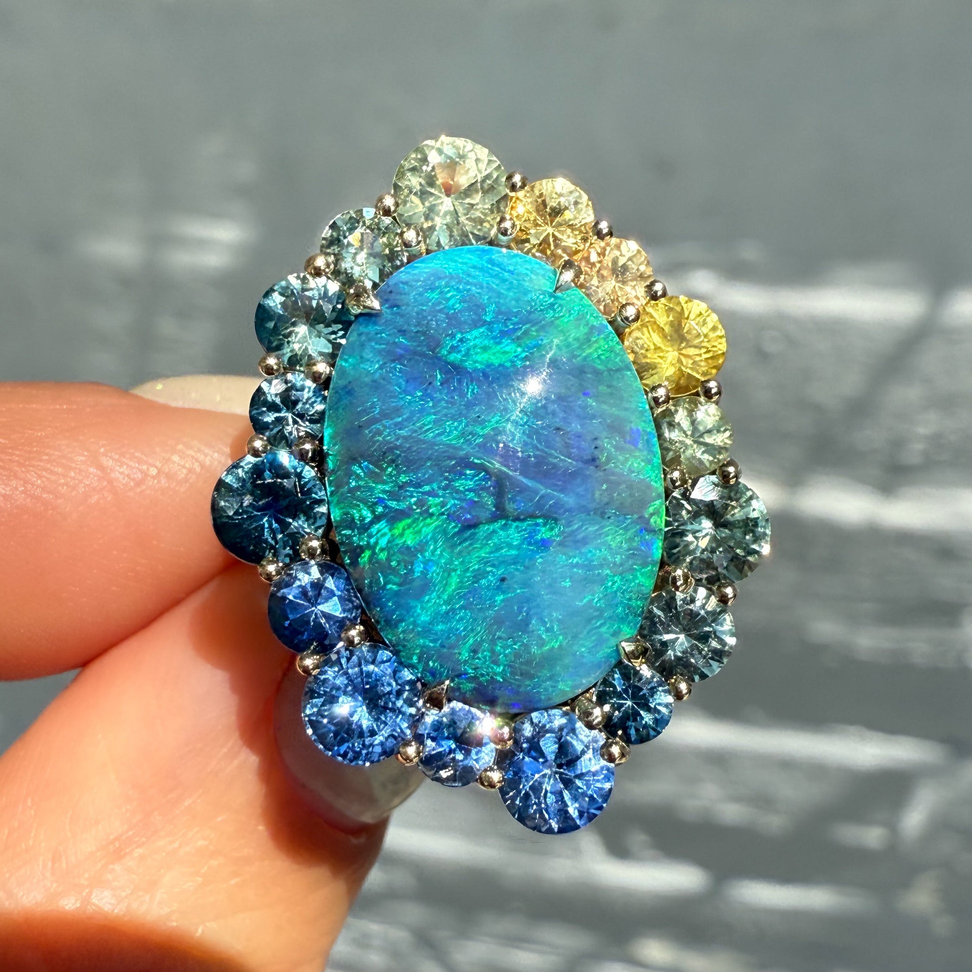 An Australian Opal Ring by NIXIN Jewelry. This rare opal ring features a black opal with intense blue and green flashes. It is a one-of-a-kind piece of luxury jewelry.