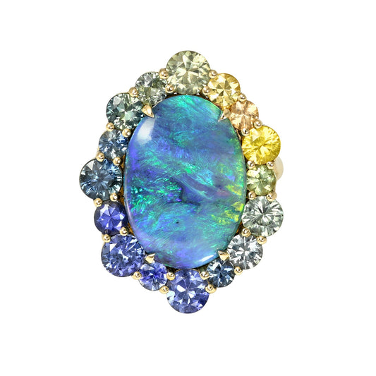 An Australian Opal Ring by NIXIN Jewelry. This unique jewelry piece features a rare black opal from Lightning Ridge. The opal stone is surrounded by a sapphire halo.