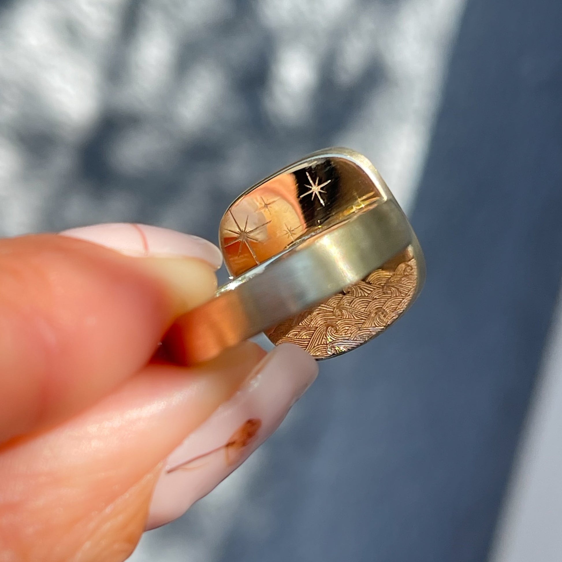 Back of an Australian Opal Ring by NIXIN Jewelry. Shows a special engraving on the gold opal ring.