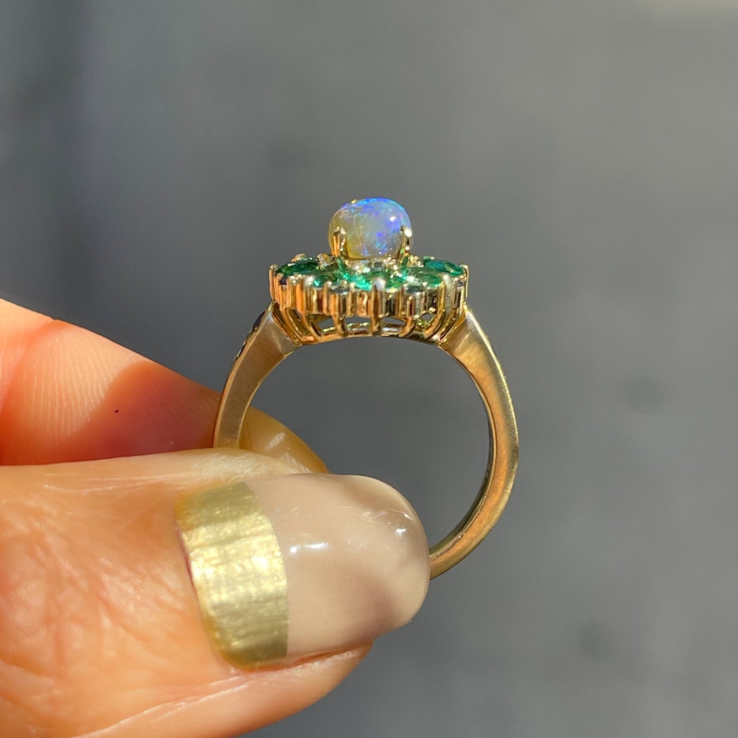 Side view of an Australian Opal Ring by NIXIN Jewelry. The black opal ring is secured by prong setting.