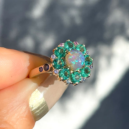 An Australian Opal Ring by NIXIN Jewelry with pink sapphires and emeralds around a lighting ridge opal.