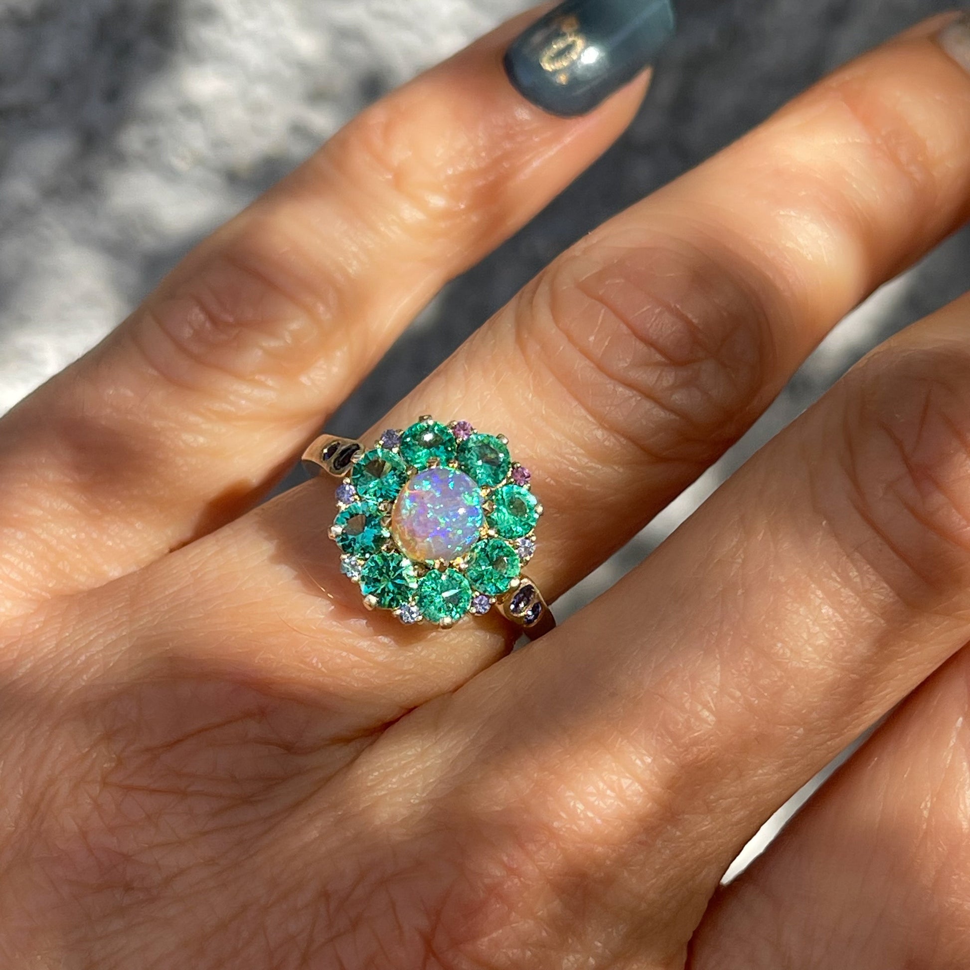 An Australian Opal Ring by NIXIN Jewelry with emeralds, sapphires and tanzanite. A unique opal ring. 