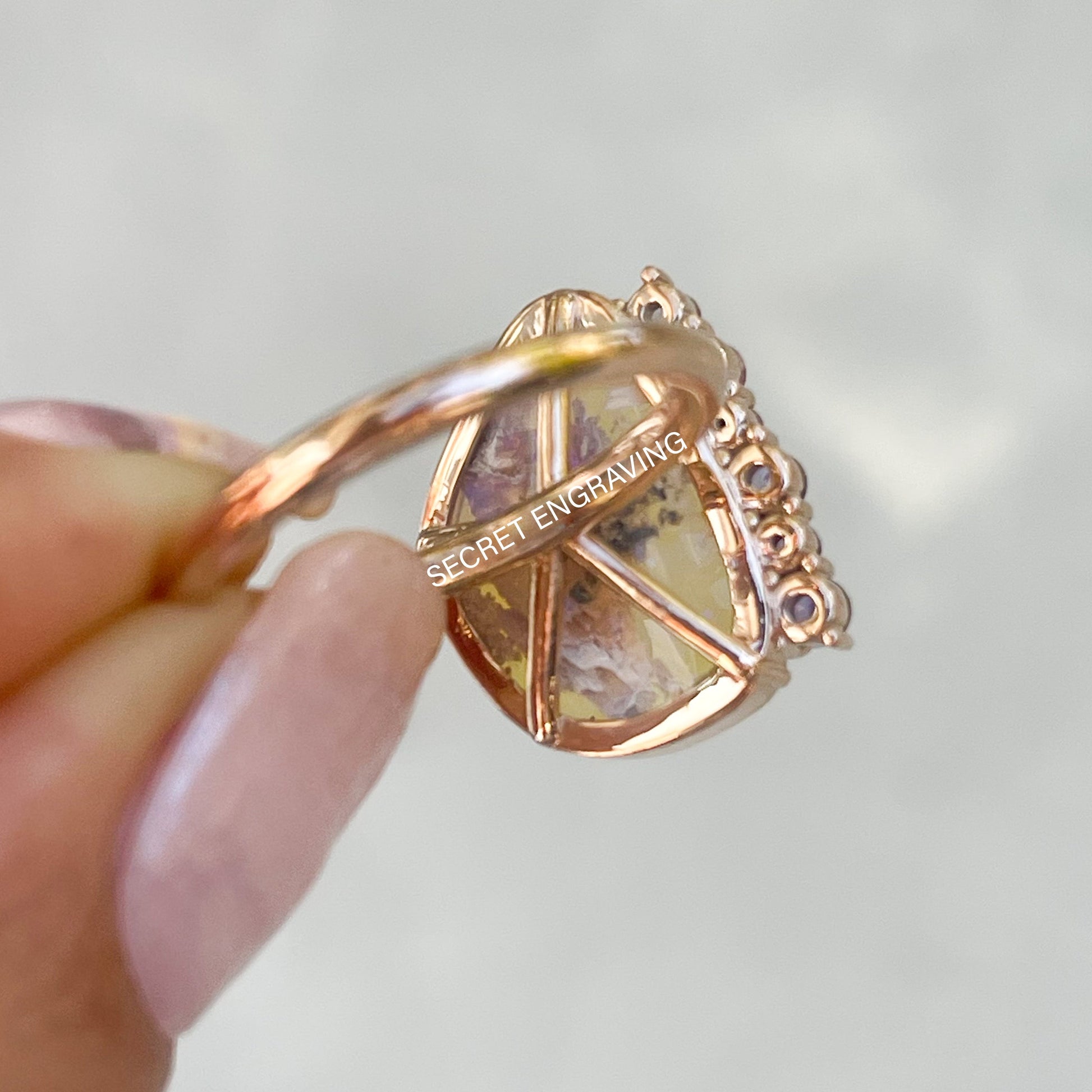 View of the back of an Australian Opal Ring by NIXIN Jewelry. The backside of the mounting and location of the secret engraving are visible in the shot.