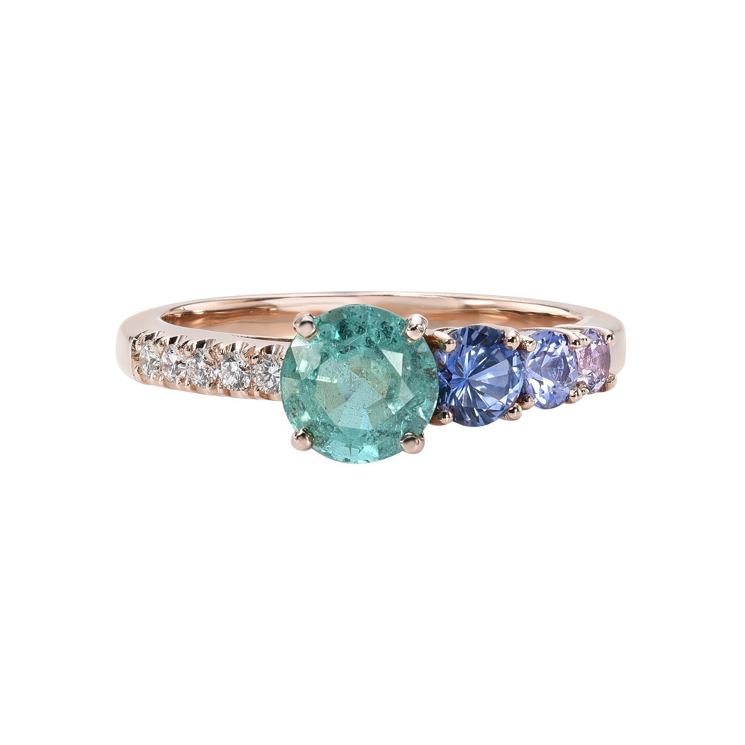 A Colombian Emerald Ring by NIXIN Jewelry against a white background. The emerald and diamond ring also has purple sapphires set in rose gold.