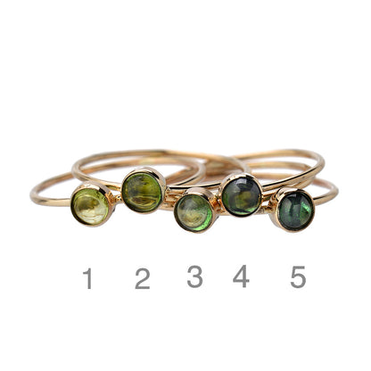 Lucky Green Tourmaline Rings numbered 1 through 5, each tourmaline cabochon a different shade of green set in 14k gold.