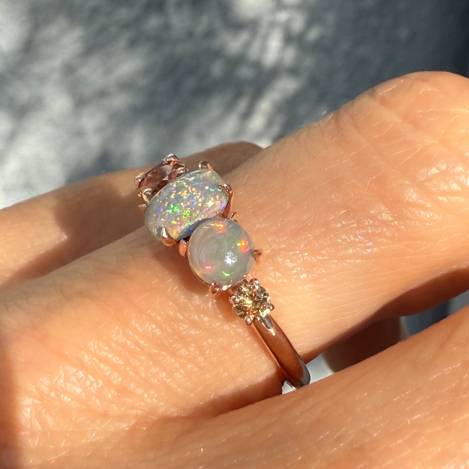 An Australian Opal Ring by NIXIN Jewelry focused on the detailed prong setting and the multi-colored fire of the natural opal center stones. The expert craftsmanship emphasizes the rarity of the semi black opal and defines this piece as high-end jewelry art. This is an authentic NIXIN black opal ring.