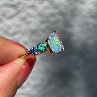 An Australian Opal Ring by NIXIN Jewelry. A rose gold opal ring with rainbow sapphires.