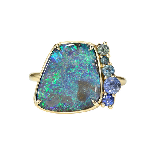 An Australian Opal Ring by NIXIN Jewelry. An opal and sapphire ring made in 14k gold. 