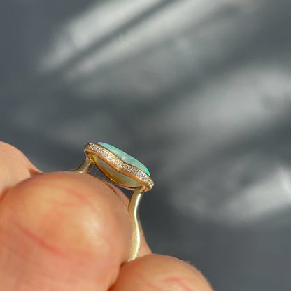 Side view of an Australian Opal Ring by NIXIN Jewelry showing profile of setting and the diamond halo.