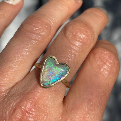 An Australian Opal Ring by NIXIN Jewelry with a green opal set in matte gold.