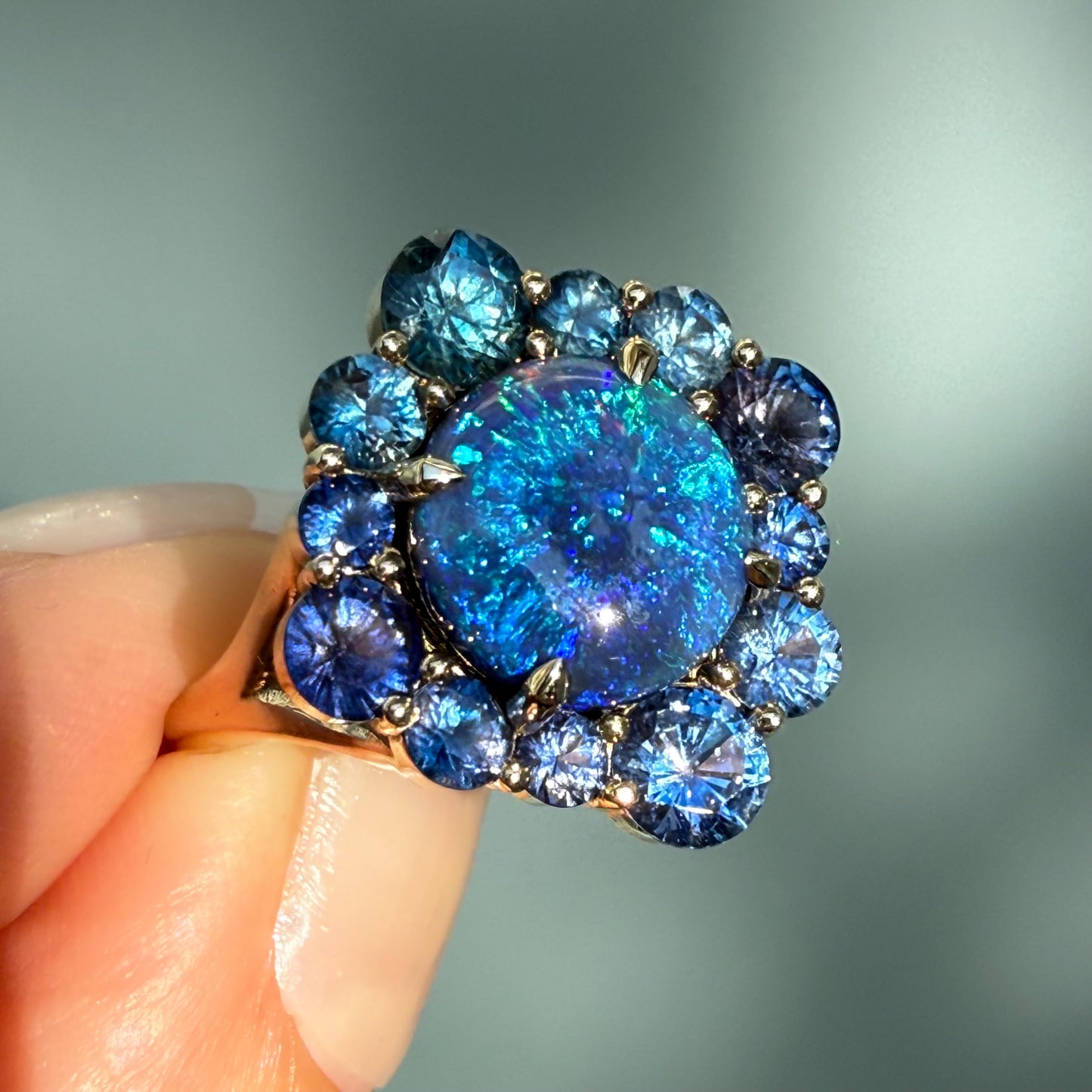An Australian Opal Ring by NIXIN Jewelry. The magnificent lightning ridge opal displays intense internal fire and deep blue opal colors, making this a spectacular cocktail ring. This design is a true piece of jewelry art and one of our signature black opal rings in our unique fine jewelry collection.