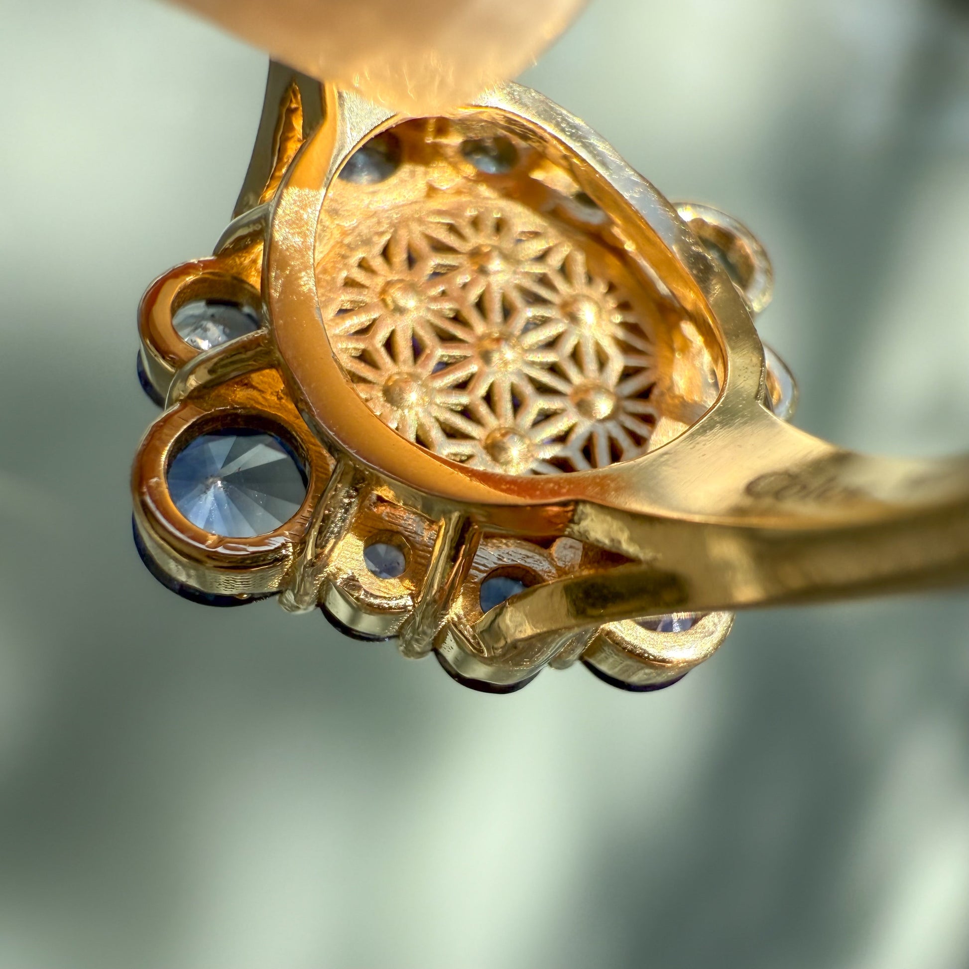 An Australian Opal Ring by NIXIN Jewelry. This detailed image reveals the intricate gold gallery pattern beneath the gemstone, a special component of our unique fine jewelry design. This 14k gold opal ring is a true piece of jewelry art.