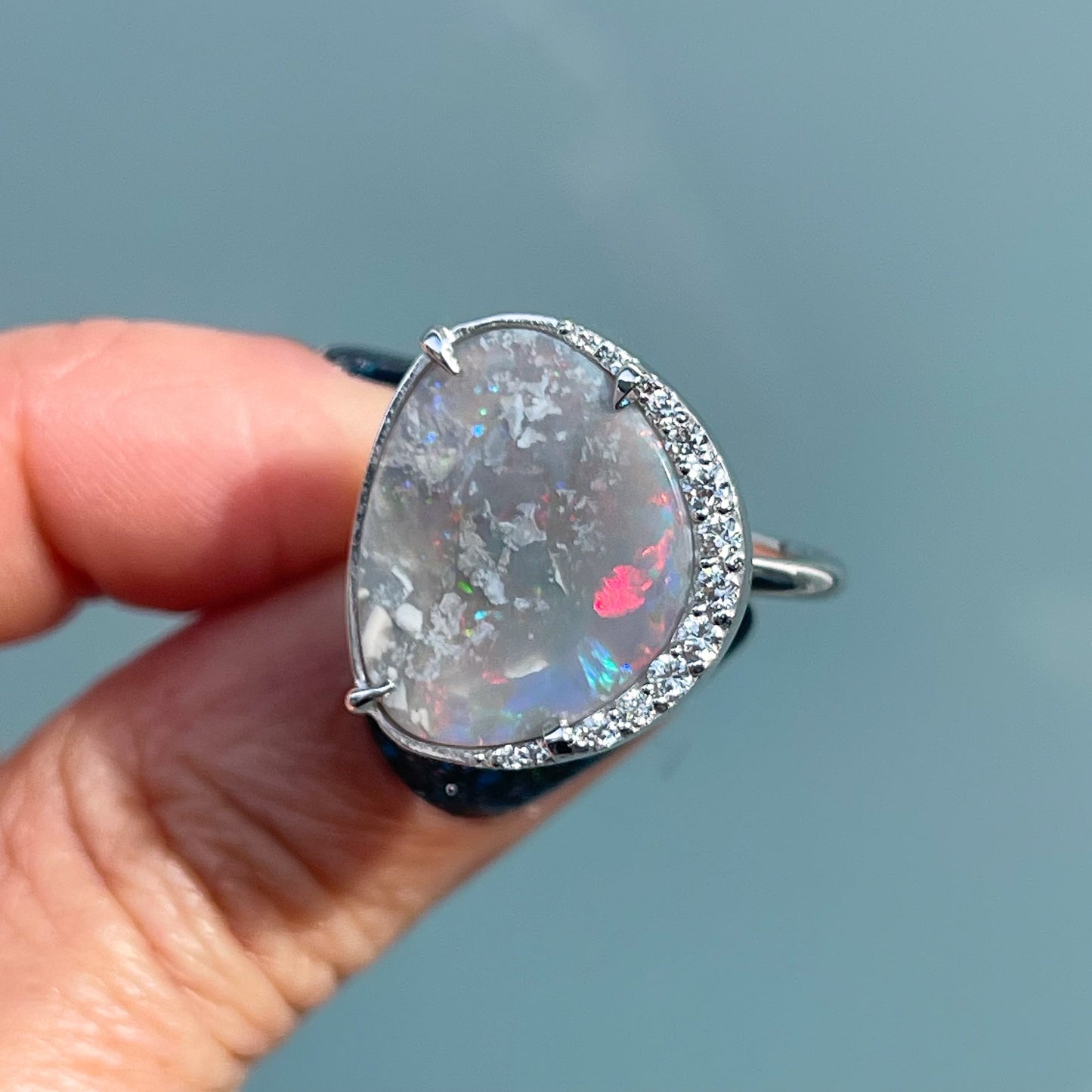An Australian Opal Ring by NIXIN Jewelry. The Black Opal ring is set in 14k white gold with diamonds.