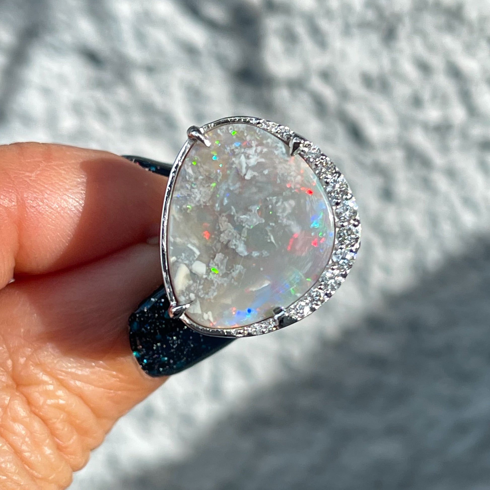 An Australian Opal Ring by NIXIN Jewelry with a large opal stone set in white gold with diamonds.