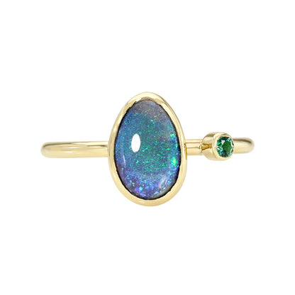 An Australian Opal Ring by NIXIN Jewelry with a black opal and an emerald.
